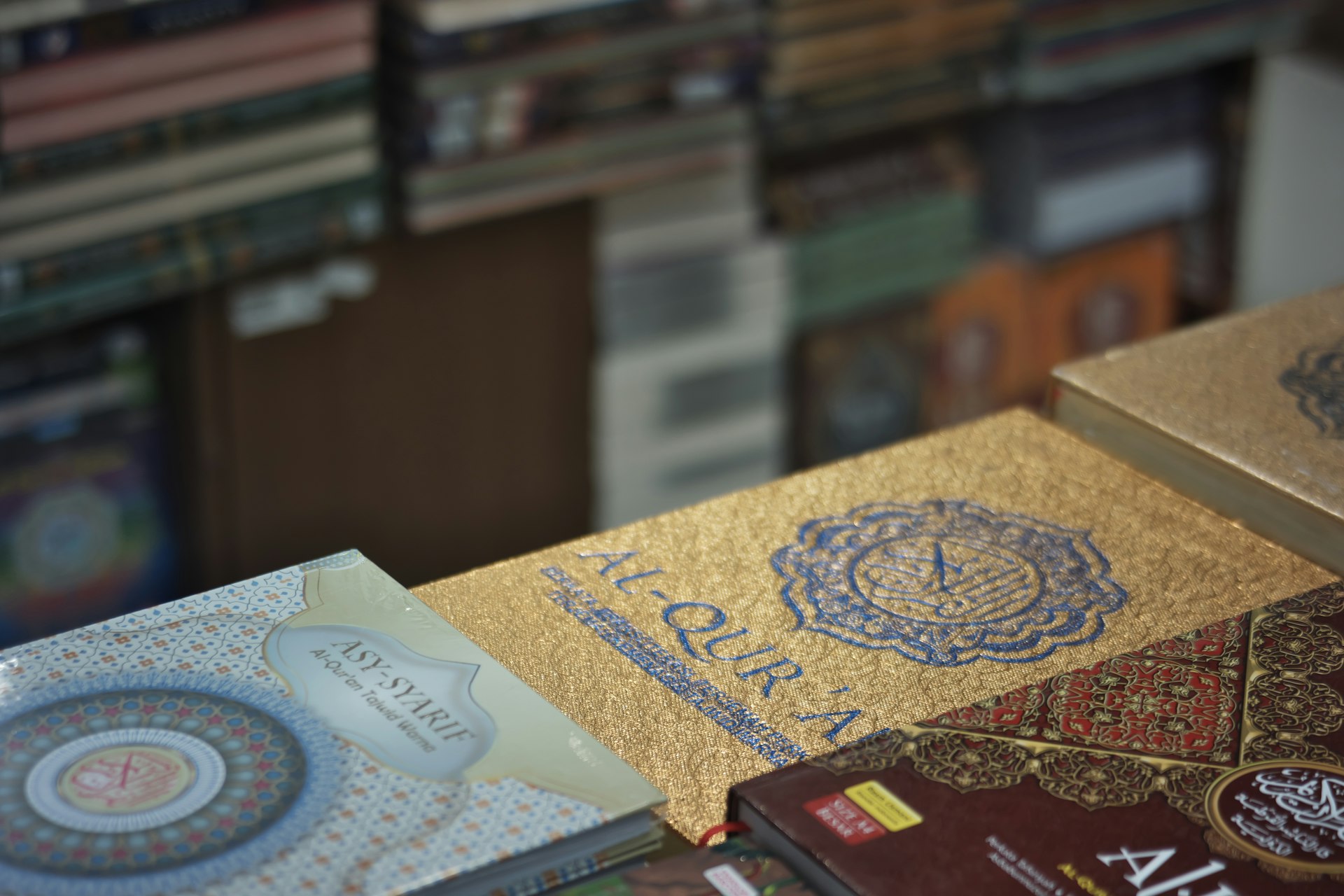 A table topped with lots of books on top of a wooden table